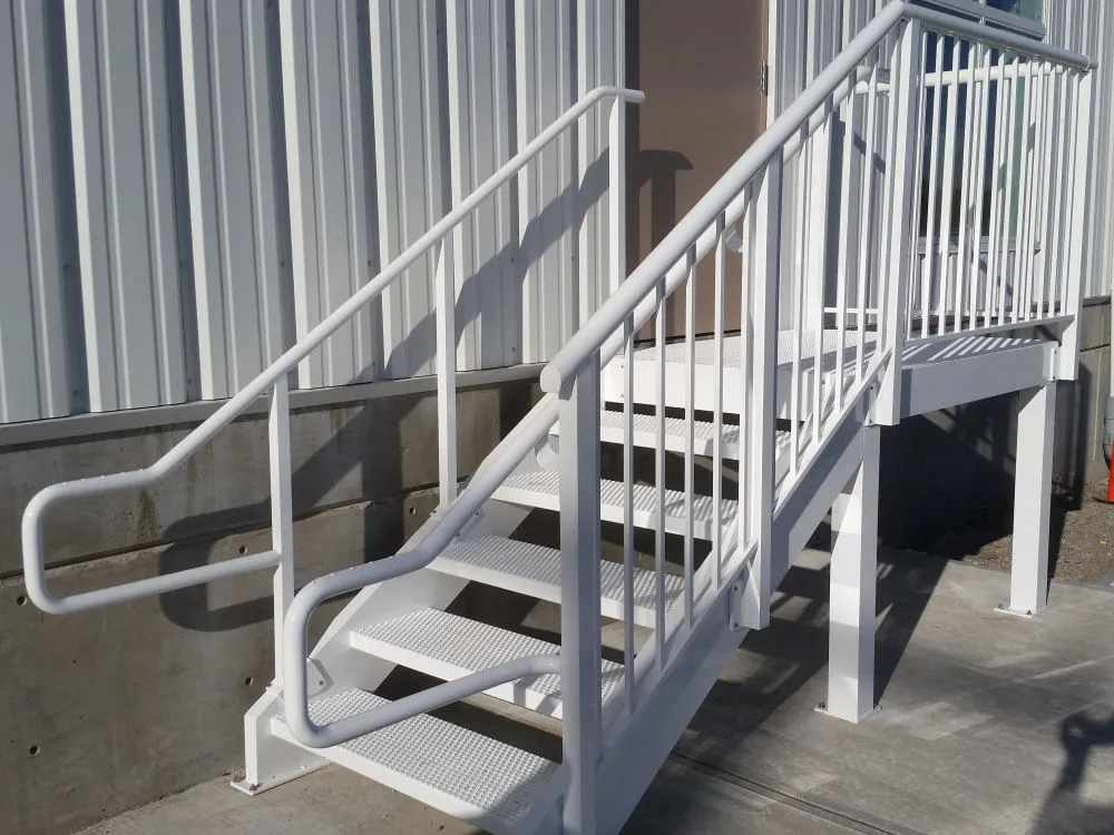 White metal stairs with handrails, reminiscent of modern aluminum and glass staircases, leading up